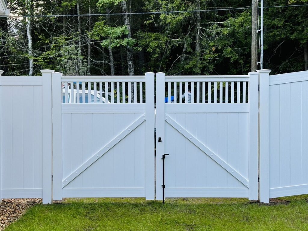 A white vinyl fence featuring a sturdy double gate installed by Ultra Fence LLC in Brookline, NH.