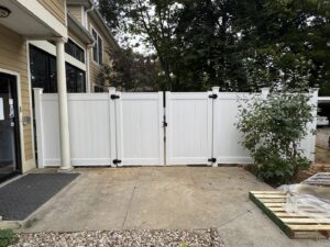 A white vinyl fence with a double gate installed by Shatkoff Fencing in Louisville, KY.