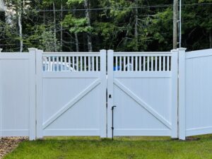 A white vinyl fence with a stylish double gate installed by Ultra Fence LLC in Brookline, NH.