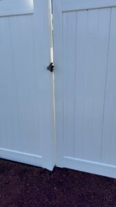 A close-up of a white vinyl fence gate installed by Clark County Fence LLC in Vancouver, WA.
