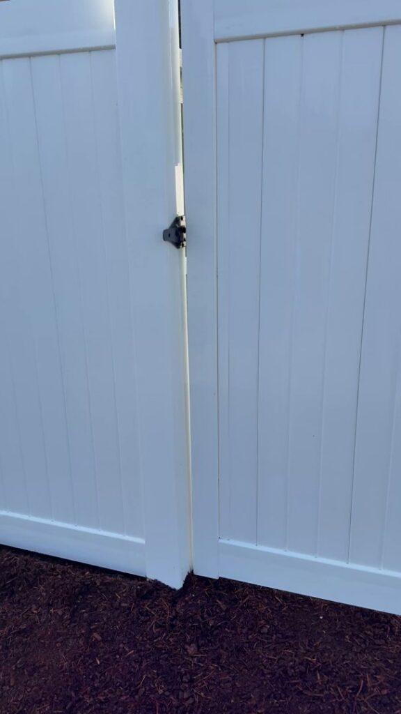 A close-up of a white vinyl fence gate installed by Clark County Fence LLC in Vancouver, WA.