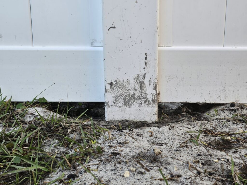Close-up of a white vinyl fence post base during installation by R&R Fence Services in Jacksonville, FL.