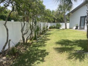 A white vinyl fence providing privacy in a residential yard, installed by Superior Fence & Rail of North Shore in Gulfport, MS.