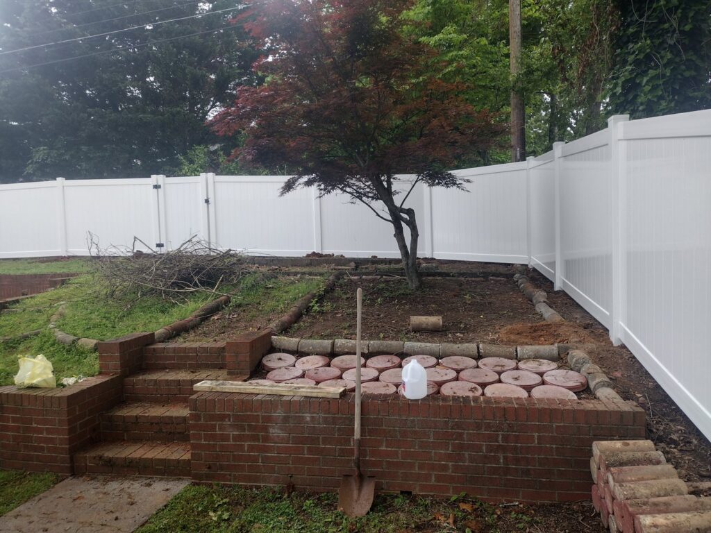 A white vinyl fence installed around a garden area by Fantastic Fences in Chattanooga, TN