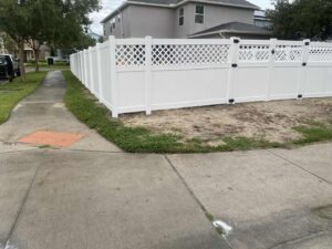 A white vinyl privacy fence with a decorative lattice top installed by Native Outdoors, LLC in Orlando, FL.