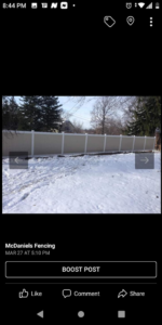 A classic white vinyl picket fence extending into the distance, installed by McDaniels Fencing in Huntington, WV.