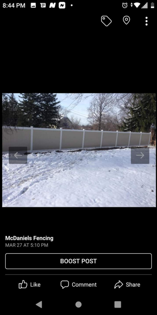 A classic white vinyl picket fence extending into the distance, installed by McDaniels Fencing in Huntington, WV.