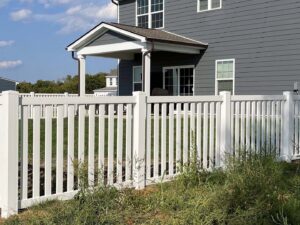 A classic white vinyl picket fence installed around a residential property by Frontier Fence LLC Bowling Green,Ky