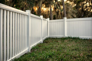A clean white vinyl picket and privacy fence installed in a residential backyard by Columbia Fence Co. in Columbia Station, OH.