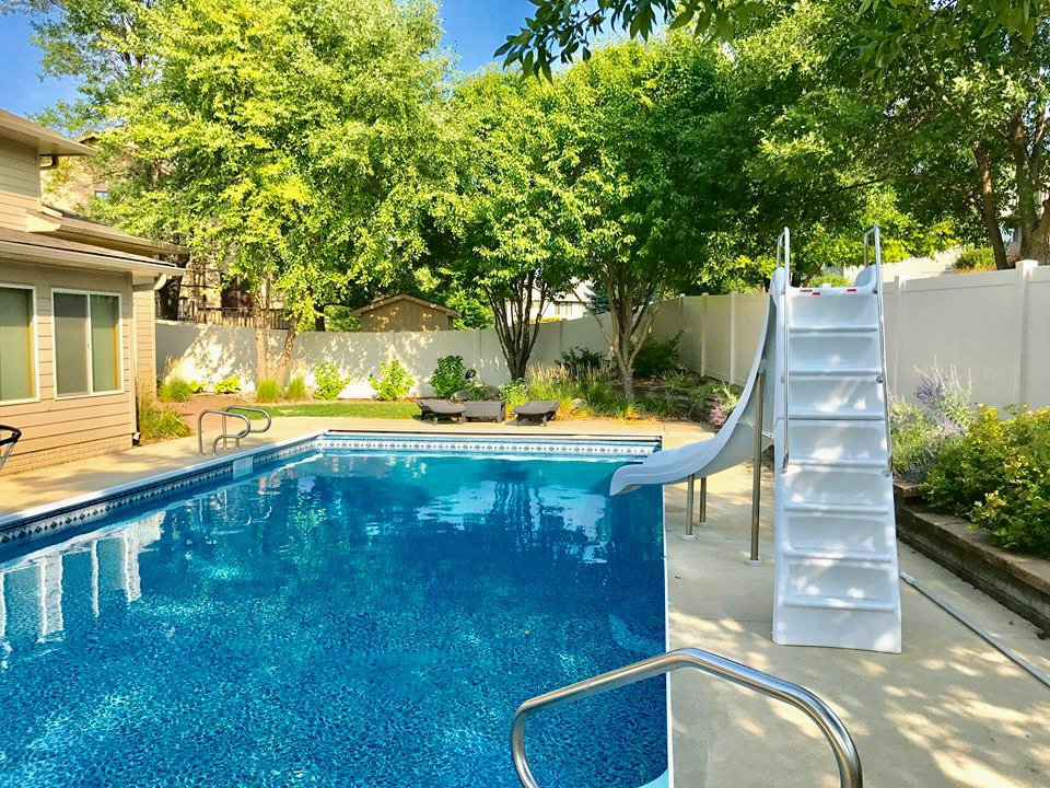 A white vinyl privacy fence installed around a swimming pool by Complete Fence, LLC in West Chicago, IL