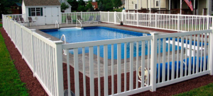 A white vinyl privacy fence enclosing a swimming pool in a backyard by Fence Masters Upstate SC in Greenville, SC