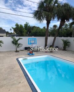 A white vinyl fence installed around a swimming pool by Santis Fence & Home Service in Tampa Heights, FL