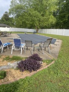 A white vinyl privacy fence installed around a swimming pool area by Pro Fence in Decatur, AL