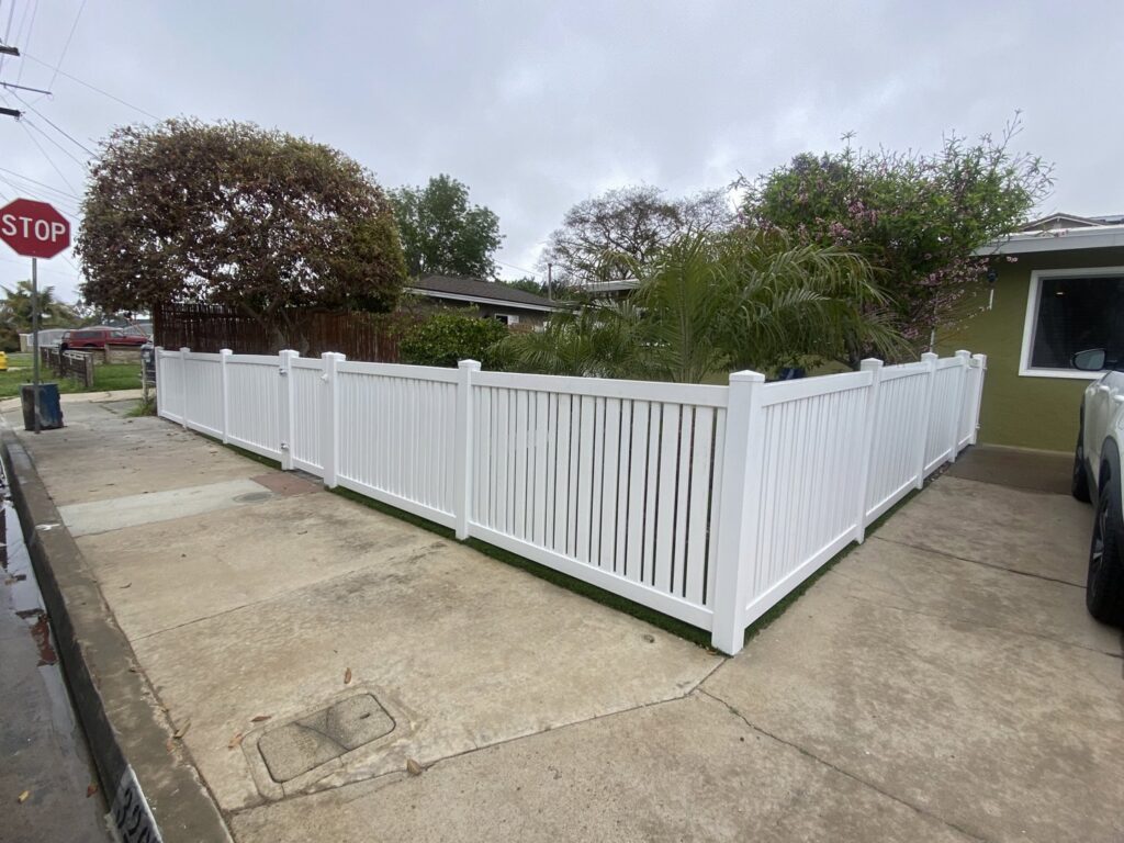 A newly installed white vinyl privacy fence around a residential property by All Around Fence Page in Imperial Beach, CA.