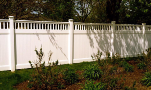 A newly installed white vinyl privacy fence by AmeriDream Fence & Deck in Joliet, IL.