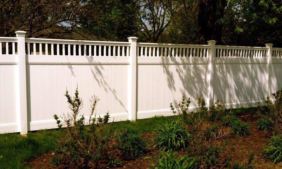 A newly installed white vinyl privacy fence by AmeriDream Fence & Deck in Joliet, IL.