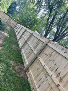 A white vinyl privacy fence installed around a building, showcasing work by Render Fences in Fishers, IN.