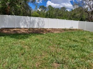 A pristine white vinyl privacy fence installed in a spacious backyard by Aarons fence in Homosassa Springs, FL