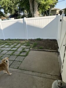A white vinyl privacy fence installed in a residential backyard by American Fence Company of Norfolk in Grand Island, NE.