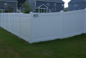 A long white vinyl privacy fence installed in a residential backyard by Big Jerry's Fencing of Boise ID in Holly Springs, NC.