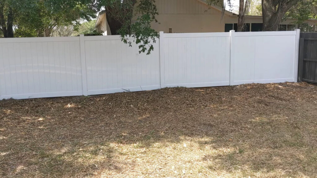 A white vinyl privacy fence installed in a backyard by Elite Fence and Outdoor of Tampa Bay in Tampa, FL.