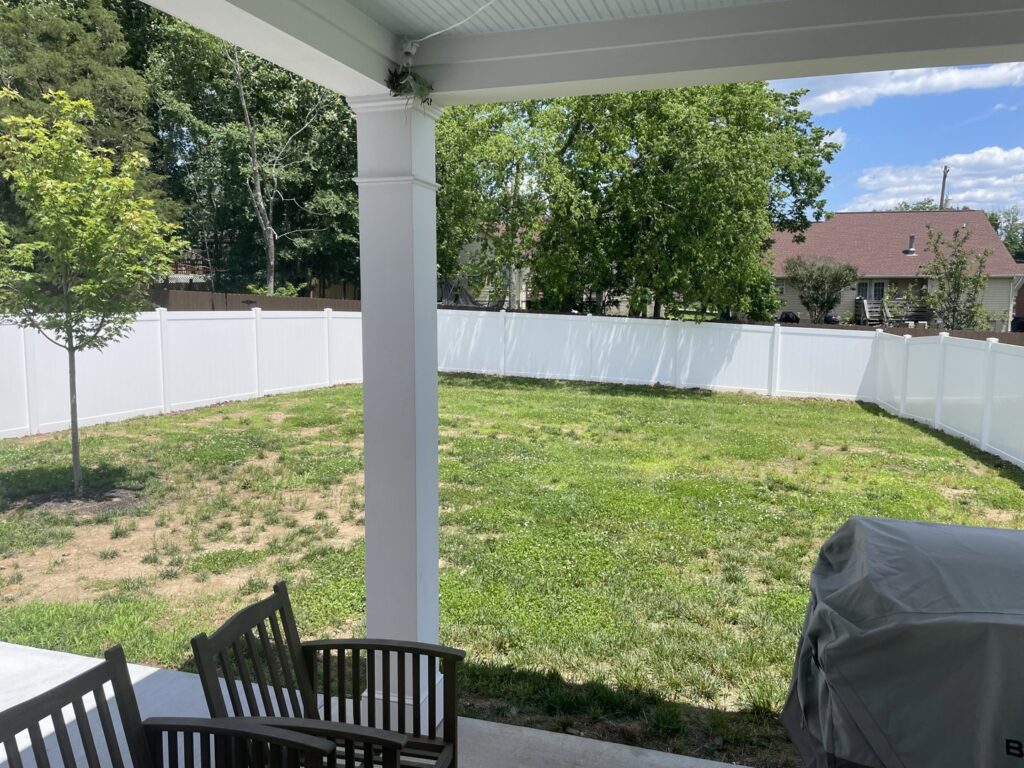 A newly installed white vinyl privacy fence enclosing a residential backyard by Fenceworks of Middle Tennessee in Nashville, TN.