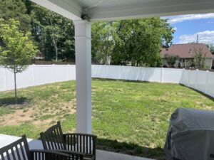 A newly installed white vinyl privacy fence enclosing a residential backyard by Fenceworks of Middle Tennessee in Nashville, TN.