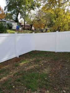 White vinyl privacy fence installed in a residential backyard by National Fence and Gate in Ironton, MO.
