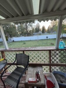 A white vinyl privacy fence viewed from a residential porch by Crows Quality Fencing in Spokane Valley, WA.