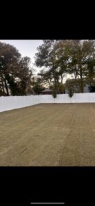 A newly installed white vinyl privacy fence enclosing a backyard by Fast Fence LLC in Bradenton, FL.