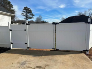 A newly installed white vinyl privacy fence with a double gate by FenceMax in Spartanburg, SC
