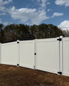 A close-up view of a white vinyl privacy fence gate installed by Brock Brothers Fence in Mobile, AL.