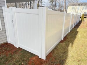 A new white vinyl privacy fence with a matching gate installed by Fenceitforu LLC in Matthews, NC.