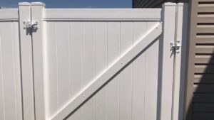A close-up view of a newly installed white vinyl privacy fence gate by Idaho Falls Fencing in Idaho Falls, ID.