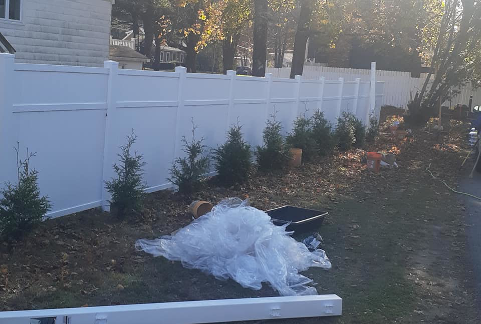 A white vinyl privacy fence installation in progress by D & G'S Maintenance LLC in Woonsocket, RI.