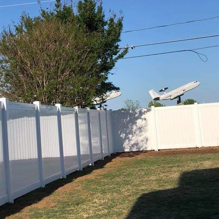 A pristine white vinyl privacy fence installed in a residential backyard by Gotta Have It Fence in Tucson, AZ.
