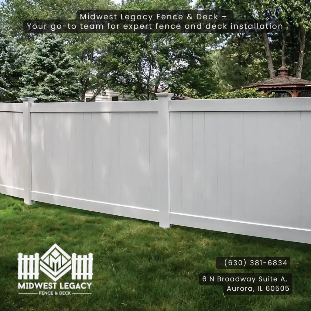 A pristine white vinyl privacy fence installed by Midwest Legacy Fence & Deck, enhancing a backyard in Aurora, IL.