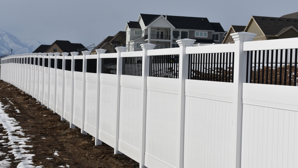 A newly installed white vinyl privacy fence with black accents by Stonehenge Fence & Deck in Orem, UT.