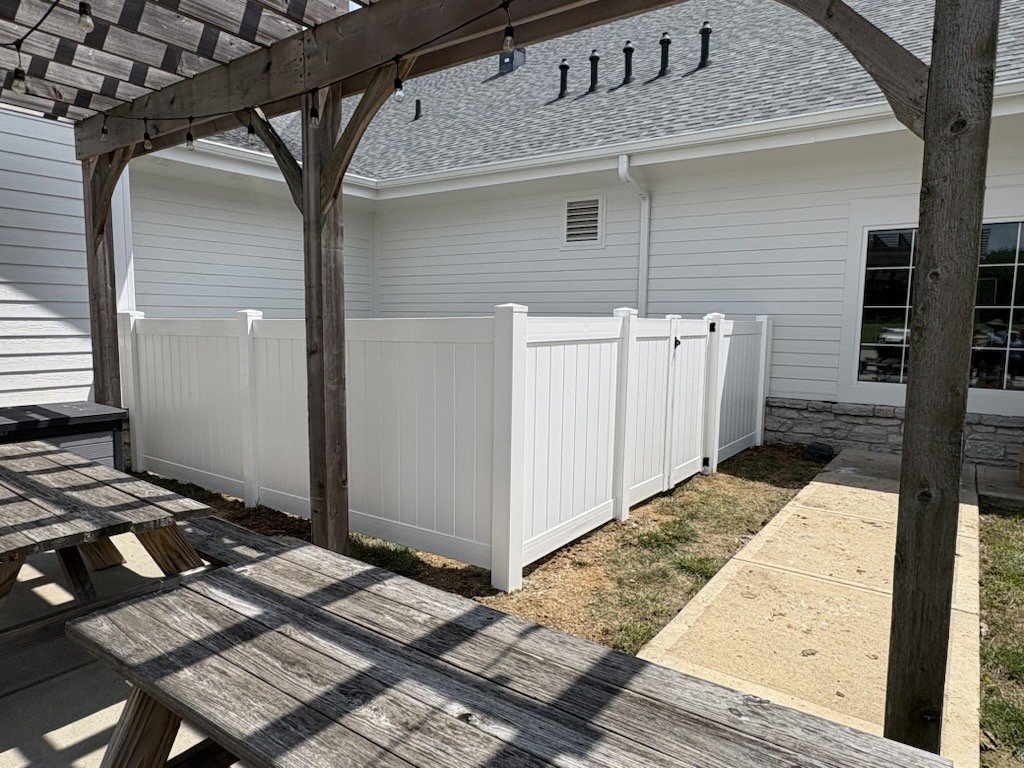 A white vinyl privacy fence enclosing an outdoor patio area at a property by Cameron Fence Builders in Indianapolis, IN.