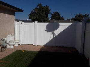 A white vinyl privacy fence enclosing a patio area installed by Angel Fencing Inc. in Fresno, CA