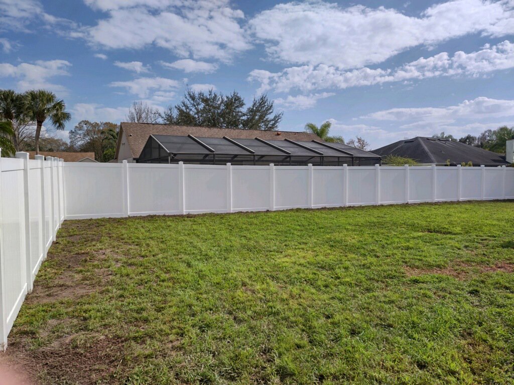 A white vinyl privacy fence enclosing a backyard with a pool area, installed by Big Jerry's Fencing of Boise ID in Holly Springs, NC.