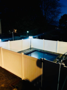 A white vinyl privacy fence installed around a swimming pool by Elite Ornamental Fence LLC in Paterson, NJ.