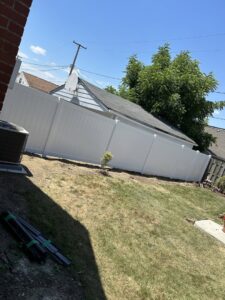 A white vinyl privacy fence installed along a residential property line by Budget Fence of Ohio in Cleveland, OH.