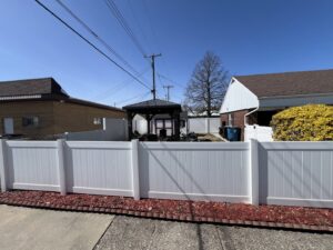 A white vinyl privacy fence installed along a property line by Premier Fence LLC in Canton, MA.