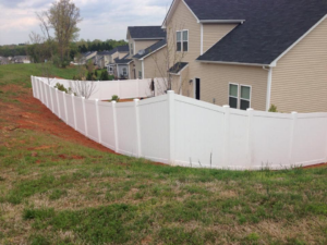 A white vinyl privacy fence installed around a residential property by Freedom Fencing of Clarksville, TN.