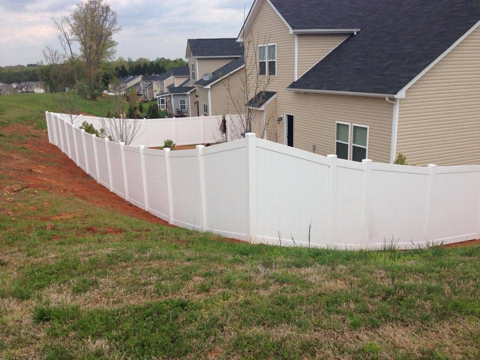 A white vinyl privacy fence installed around a residential property by Freedom Fencing of Clarksville, TN.