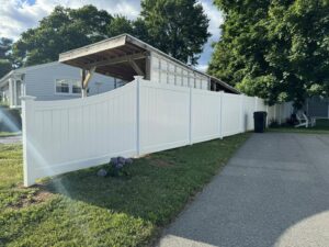 A white vinyl privacy fence installed along a residential property by Select Fence & Guardrail in North Haven, CT.