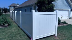 A clean white vinyl privacy fence installed along a residential property by Superior Fence & Rail of Charlotte, NC