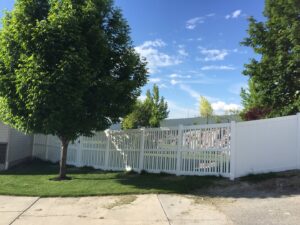 A white vinyl privacy and picket style fence installed by Sublime Fencing LLC in North Logan, UT.