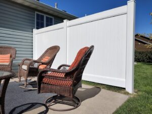 A white vinyl privacy screen fence installed for a patio area by Aces Deck and Fence in Fargo, ND